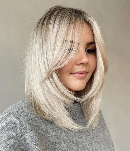 girl with mid length haircut with face framing layers 