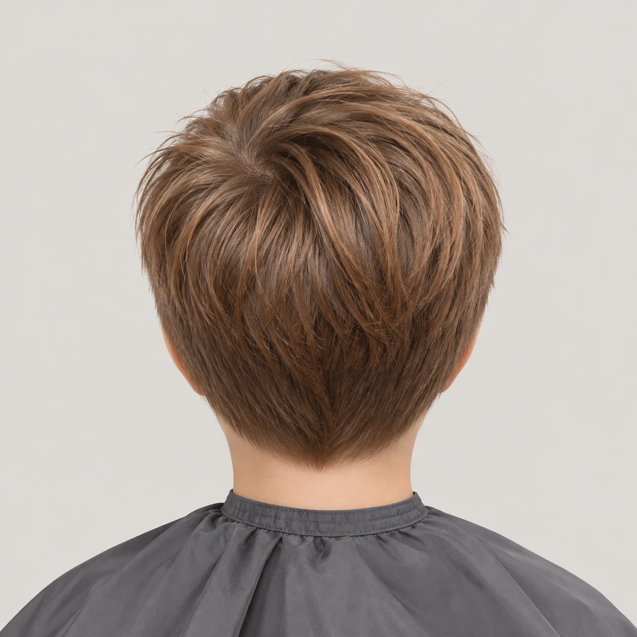 A short light-brown haircut with a softly tapered neckline.