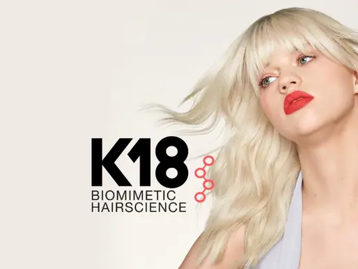 k18 biomimetic hairscience girl with platinum blonde hair and red lipstick