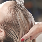 girl having a treatment rinsed from her hair