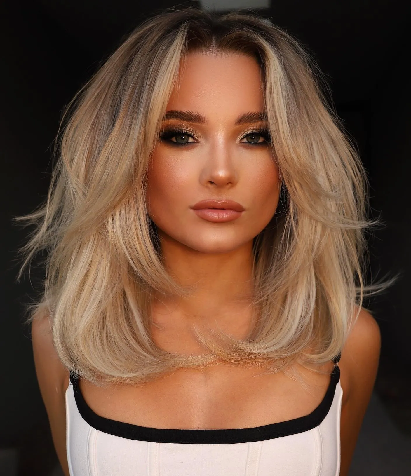 girl with mid length haircut with face framing layers 