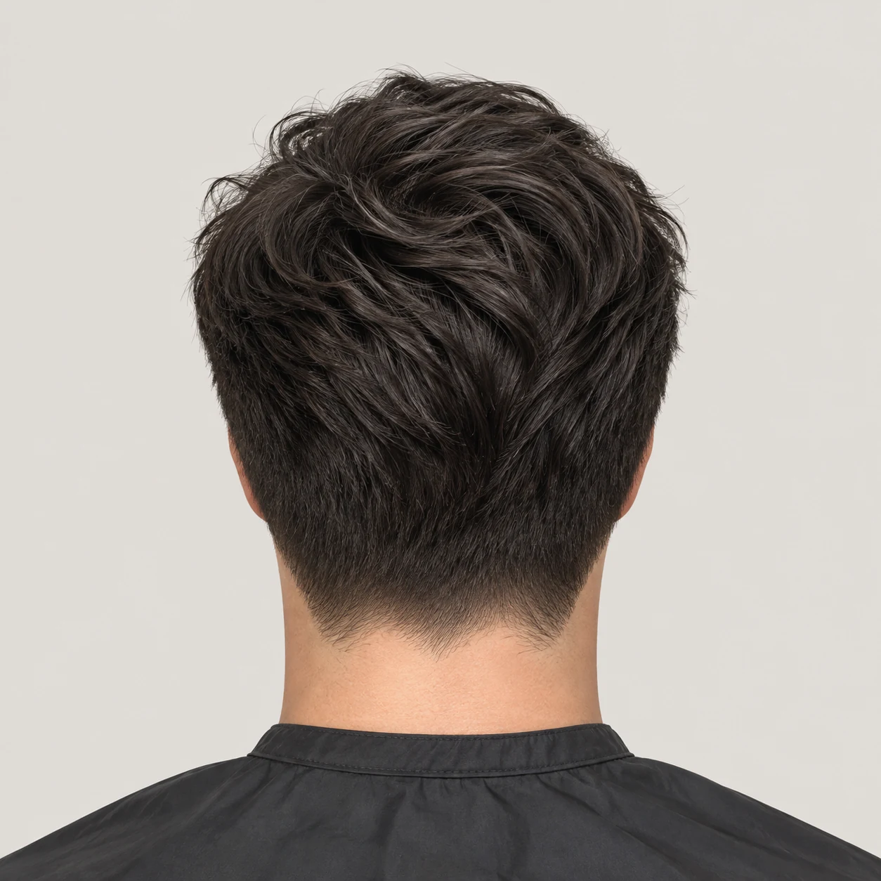 A classic short haircut with a clean tapered neckline and textured top.
