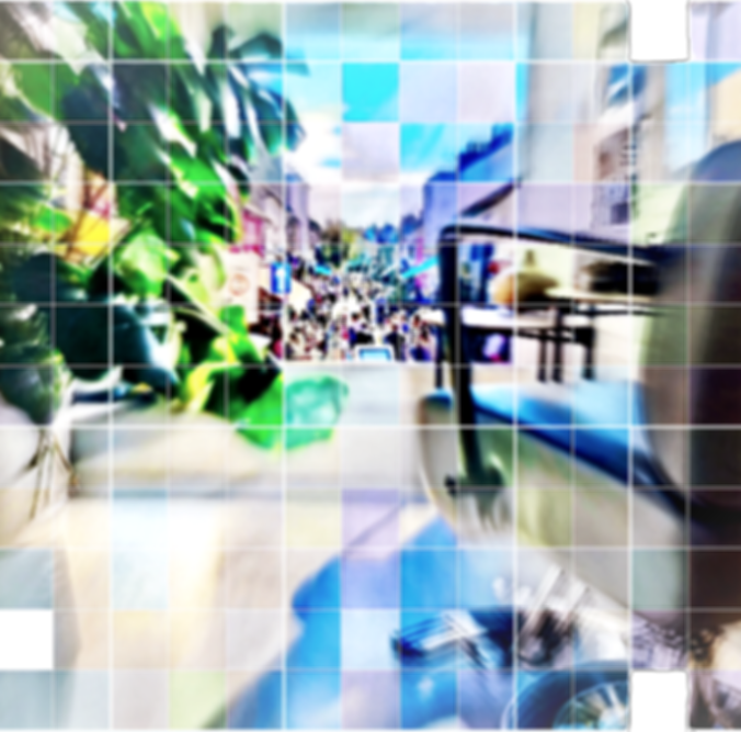 view of busy street from the window of a hair salon with a large green plant and a salon chair facing the open window