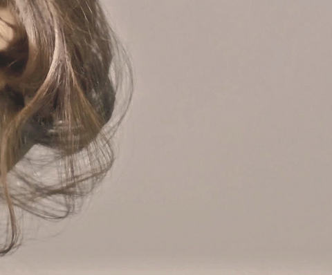 soft collection of brunette hair to the left of the screen