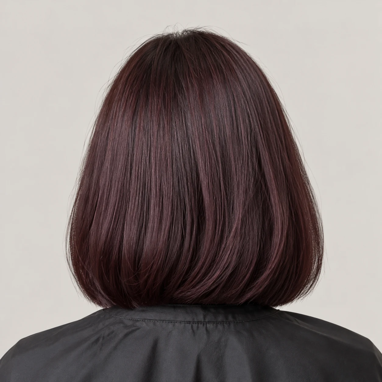 A brunette bob with even plum-toned colour from roots to ends.