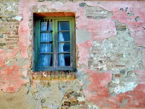 Monterongriffoli: A window with net curtains left many years ago by the last occupant