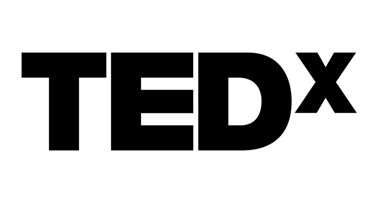 Official TEDx black typographic logo, representing global public speaking authority and executive thought leadership by Lachandra B. Baker.