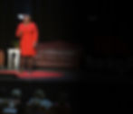 Keynote speaker Lachandra B. Baker, MBA, CDP, delivers her TEDx address to a large, engaged live audience, showcasing authentic professional energy.
