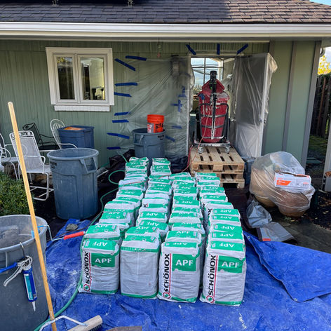 Workers mixing and applying self leveler to a floor