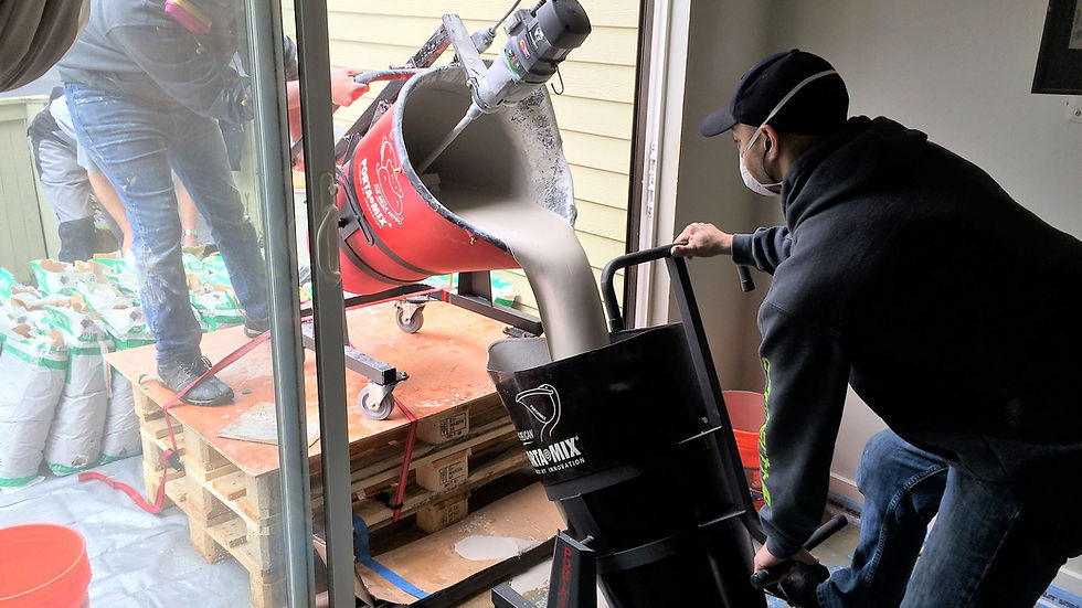 Workers mixing and transporting cement-based self-leveling product for floor applications
