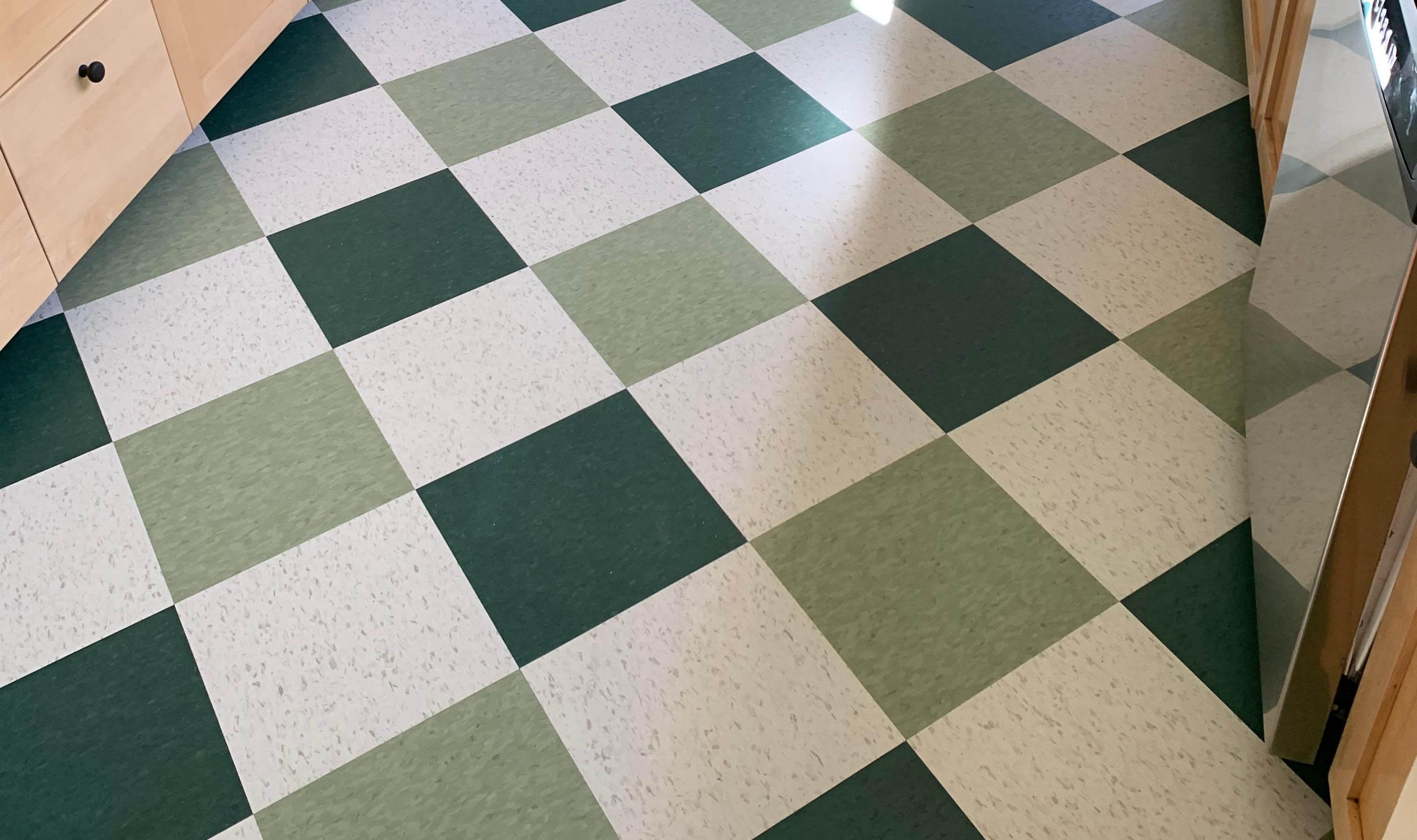 Marmoleum MCT tile installed in a kitchen using a custom pattern with three different colors.
