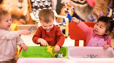 Children playing in a sensory bin.