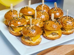 mini-chicken-burgers-white-plate-cook-is-holding-plate-her-arms-diagonal-composition_58388