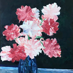 Varying shades of pink peonies in a blue vase 