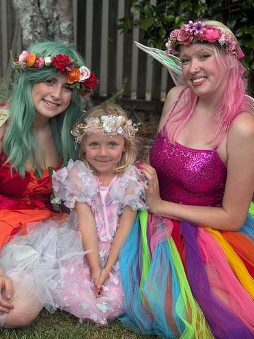 rainbow fairy and forrest fairy with birthday child in children birthday party entertainment