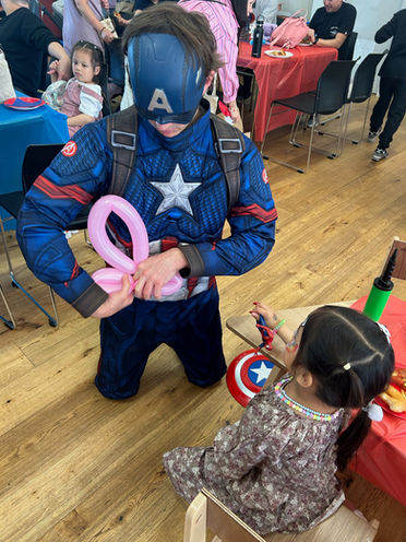 captain america doing balloon twisting at kids birthday party entertainment
