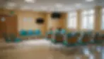 Eye-level view of a hospital waiting room with empty chairs
