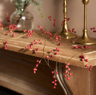 red berry garland on mantel, holiday decor by Hem Collective