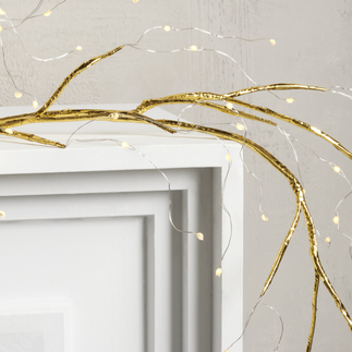 gold branch and fairly light garland on mantel, holiday decor by Hem Collective