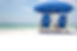 Two chairs and one umbrella set up behind Destin Beach Club