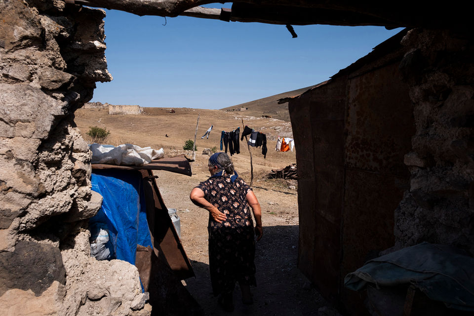 Aybeniz Kalenderova, who had to leave her village because of the First Nagorno-Karabakh War, walks around the village.