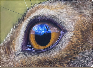 Detailed painting of an animal’s eye with golden iris reflecting a landscape scene of blue sky and tree.