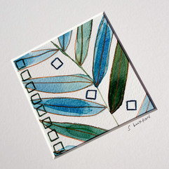 Watercolour artwork of a series of leaves with a stitched design embroidered onto the paper