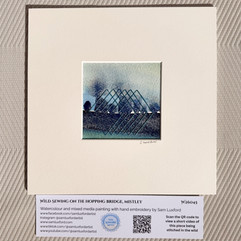 Watercolour artwork with a stitched design embroidered onto the paper. Underneath is info about the piece, and a QR code