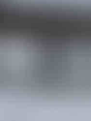 Woman standing on a frozen lake embroidering onto paper