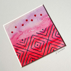 Watercolour artwork with a stitched design embroidered onto the paper.