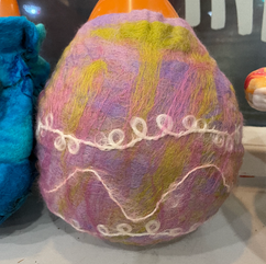 Mauve, and green felted bowl with an orange balloon former inside
