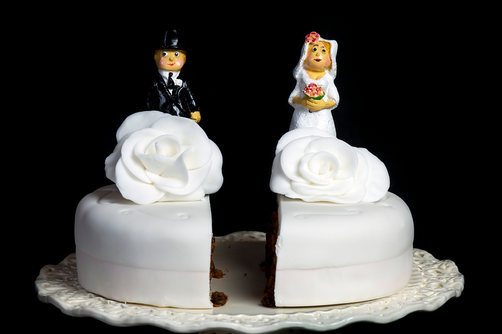 bride and groom on wedding cake split in half
