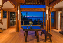 Sleek and contemporary custom-built home with large windows, clean lines, and high-quality finishes, blending seamlessly with North Vancouver's natural surroundings.