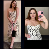 Photo titled "Babe with a Mobility Aid". Photo collage of a young woman wearing a Dalmatian printed, black and white dress. She's using two mobility aids - a black knee brace and a pink cane. She's holding her phone which also has a pink case. She's posing in a flirty pose in both photos.