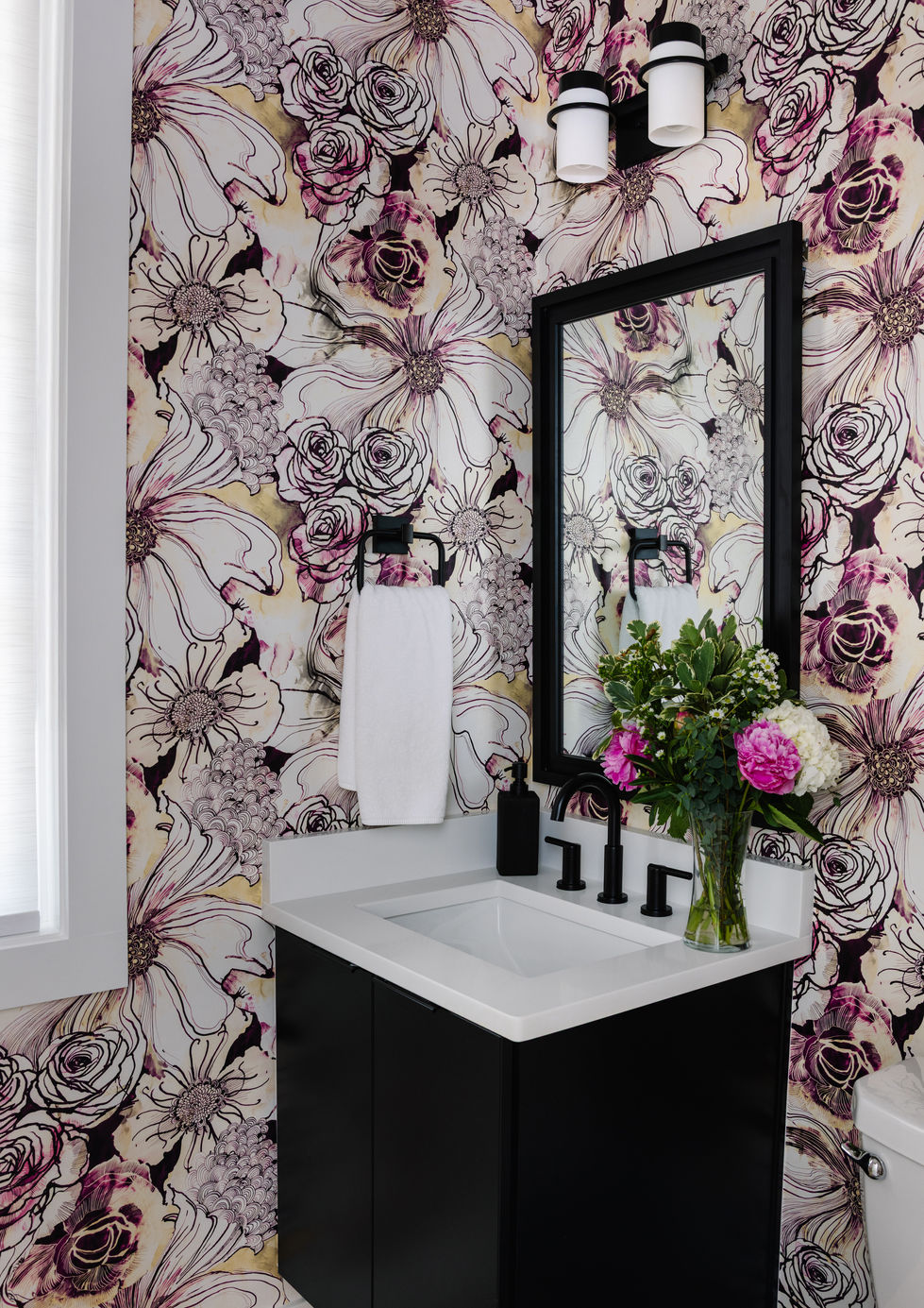 Bathroom with bold, rose wallpaper. Designed by ASF Interiors.