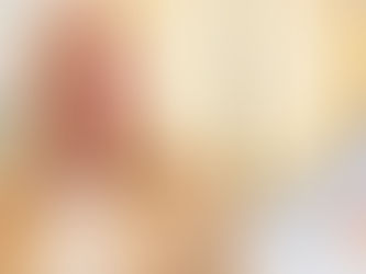 Stylish designer against a white wall, accompanied by two, large, bronze lights