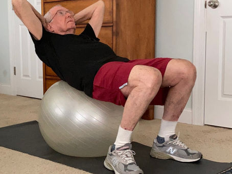 Pete Sutton doing balance exercise on an exercise ball