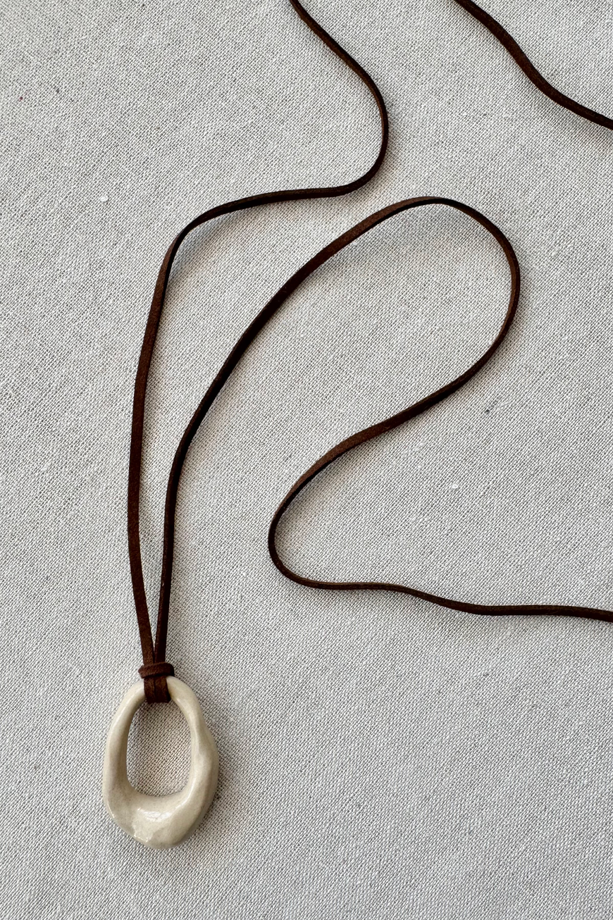 Bone Pendant In Brown
