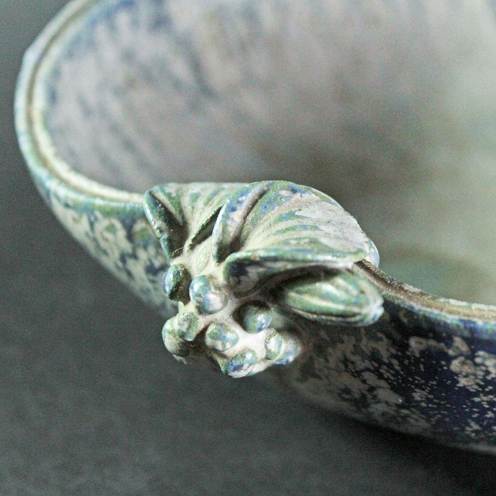 Thumbnail: Detailed view of the hand-pinched leaf decoration and sculptural handle on the Arne Bang stoneware bowl.