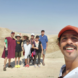Sagi Levy with a large multi-generational family at a scenic overlook in the Judean Desert.