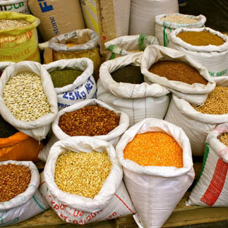 "Burlap sacks filled with colorful Israeli spices, lentils, and grains at Machane Yehuda Market."