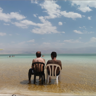 Visitors effortlessly floating in the Dead Sea, demonstrating why the high salt concentration makes it impossible to sink.
