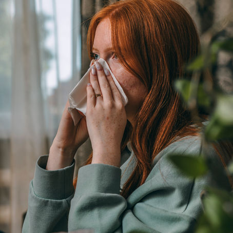 Woman with Allergies, Tips from Topeka ENT can help discern if it’s seasonal or mold allergies. 