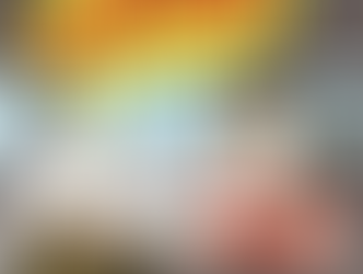 A man sitting behind the wheel of his van with his cat sitting in a carrier in the front seat