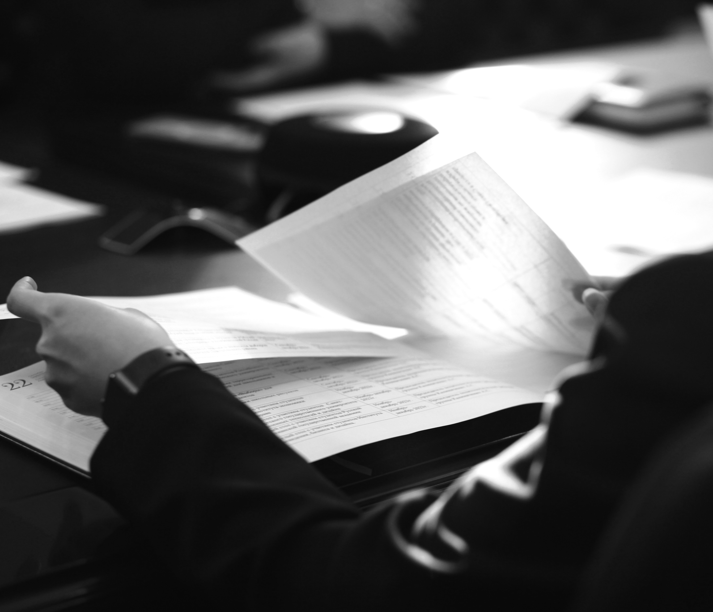 Close-up of a professional examining contract paperwork for accuracy and compliance.