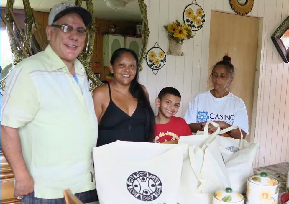 UCTP Board Member Roger "Guayakan" Hernandez distributing hurricane relief packages to the Cheverez Family in Morovis, Borikén in 2018.