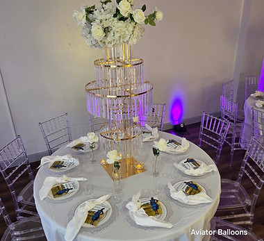 Polished table arrangement in Brooklyn including charger plates, tealights, and elegant fl