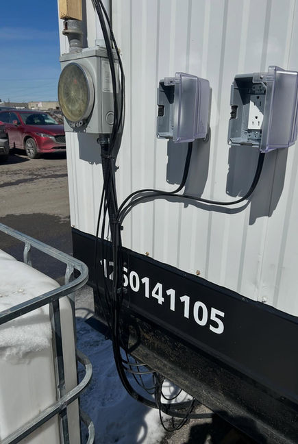 Electrical components with the number 130141105. Grey boxes, black wires, electrical work outside