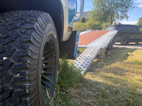 SUV gets loaded on a trailer