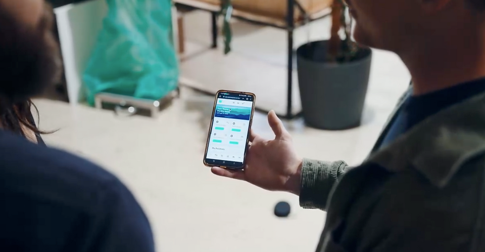 Roaster holding a mobile with greensquare showing